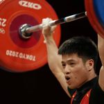 
              Li Fabin of China competes in the men's 61kg weightlifting event, at the 2020 Summer Olympics, Sunday, July 25, 2021, in Tokyo, Japan. (AP Photo/Luca Bruno)
            
