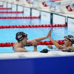 
              Kathleen Ledecky, of the United States, left high-fives teammate Katie Grimes after Ledecky won the women's 800-meter freestyle final at the 2020 Summer Olympics, Saturday, July 31, 2021, in Tokyo, Japan. (AP Photo/David Goldman)
            