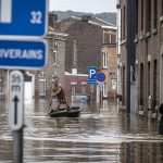 
              A man rows a boat down a residential street after flooding in Angleur, Province of Liege, Belgium, Friday July 16, 2021. Severe flooding in Germany and Belgium has turned streams and streets into raging torrents that have swept away cars and caused houses to collapse. (AP Photo/Valentin Bianchi)
            