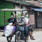 
              FILE - In this July 28, 2021, file photo, people wearing face masks to help curb the spread of the coronavirus ride a tricycle to transport goods in Shwe Pyi Thar township in Yangon, Myanmar. With coronavirus deaths rising in Myanmar, there are growing allegations from residents and human rights activists that the military government, which seized control in February, is using the pandemic to consolidate power and crush opposition. (AP Photo, File)
            