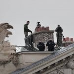 
              Security work on a rooftop at the Place de la Concorde prior to the Bastille Day parade in Paris, Wednesday July 14, 2021. Bastille Day is the French national holiday that commemorates the beginning of the French Revolution on July 14, 1789. (AP Photo/Lewis Joly)
            