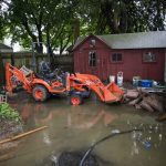 
              The back yard of a house is seen partially flooded during the passing of Tropical Storm Henri in Helmetta, N.J., Monday, Aug. 23, 2021. (AP Photo/Eduardo Munoz Alvarez)
            