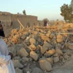 
              An Afghan man stands near a damaged house after airstrikes in two weeks ago during a fight between government forces and the Taliban in Lashkar Gah, Helmand province, southwestern, Afghanistan, Saturday, Aug. 21, 2021. (AP Photo/Abdul Khaliq)
            