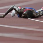 
              FILE - In this Aug. 6, 2021, file photo, Paul Chelimo, of United States, lies on the track after the final of the men's 5,000-meters at the 2020 Summer Olympics in Tokyo. (AP Photo/Petr David Josek, File)
            