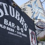 A sign for Stubb's BBQ and Amphitheater appears outside the establishment in Austin, Texas, on Aug. 21, 2021. The music industry is moving toward vaccine mandates for concertgoers, but local and state laws have created murky legal waters for COVID-19 rules in venues. Texas state law says businesses can't require customers to show proof of a COVID-19 vaccination. (AP Photo/Chuck Burton)