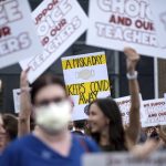 
              People in favor of and against a mask mandate for Cobb County schools gather and protest ahead of the school board meeting Thursday, Aug. 19, 2021, in Marietta, Ga. (Ben Gray/Atlanta Journal-Constitution via AP)
            