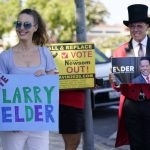 
              Supporters of the California recall of Gov. Gavin Newsom and Republican candidate Larry Elder hold signs outside of a debate by Republican gubernatorial candidates at the Richard Nixon Presidential Library Wednesday, Aug. 4, 2021, in Yorba Linda, Calif.  Newsom faces a Sept. 14 recall election that could remove him from office. (AP Photo/Marcio Jose Sanchez)
            