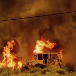 A bulldozer creates a firebreak as the Dixie Fire burns south of Janesville in Lassen County, Calif., on Tuesday, Aug. 17, 2021. Critical fire weather throughout the region has spread multiple wildfires burning in Northern California. (AP Photo/Noah Berger)