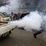 
              Volunteers on a vehicle spray to disinfect market area in an effort to contain the outbreak of the coronavirus, in Karachi, Pakistan, Monday, Aug. 2, 2021. (AP Photo/Fareed Khan) (AP Photo/Fareed Khan)
            