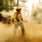 
              Northern Sonoma County Fire District firefighters Erik Padilla, right, and Joe Young extinguish hot spots while protecting Lake Almanor West homes from the Dixie Fire on Thursday, Aug. 5, 2021, in Plumas County, Calif. They work out of the Geyserville Fire Station. (AP Photo/Noah Berger)
            