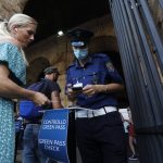 
              Tourists have their "green pass" checked by security staff at the entrance of the Colosseum in Rome, Italy, Friday, Aug. 6, 2021. The so-called Green Pass, required from Friday to access indoor dining, theaters, indoor swimming pools, gyms, museums and other gathering places is granted to anyone with at least one dose of vaccine in the last nine months, who has recovered from COVID-19 in the last six months or tested negative in the previous 48 hours. (AP Photo/Riccardo De Luca)
            