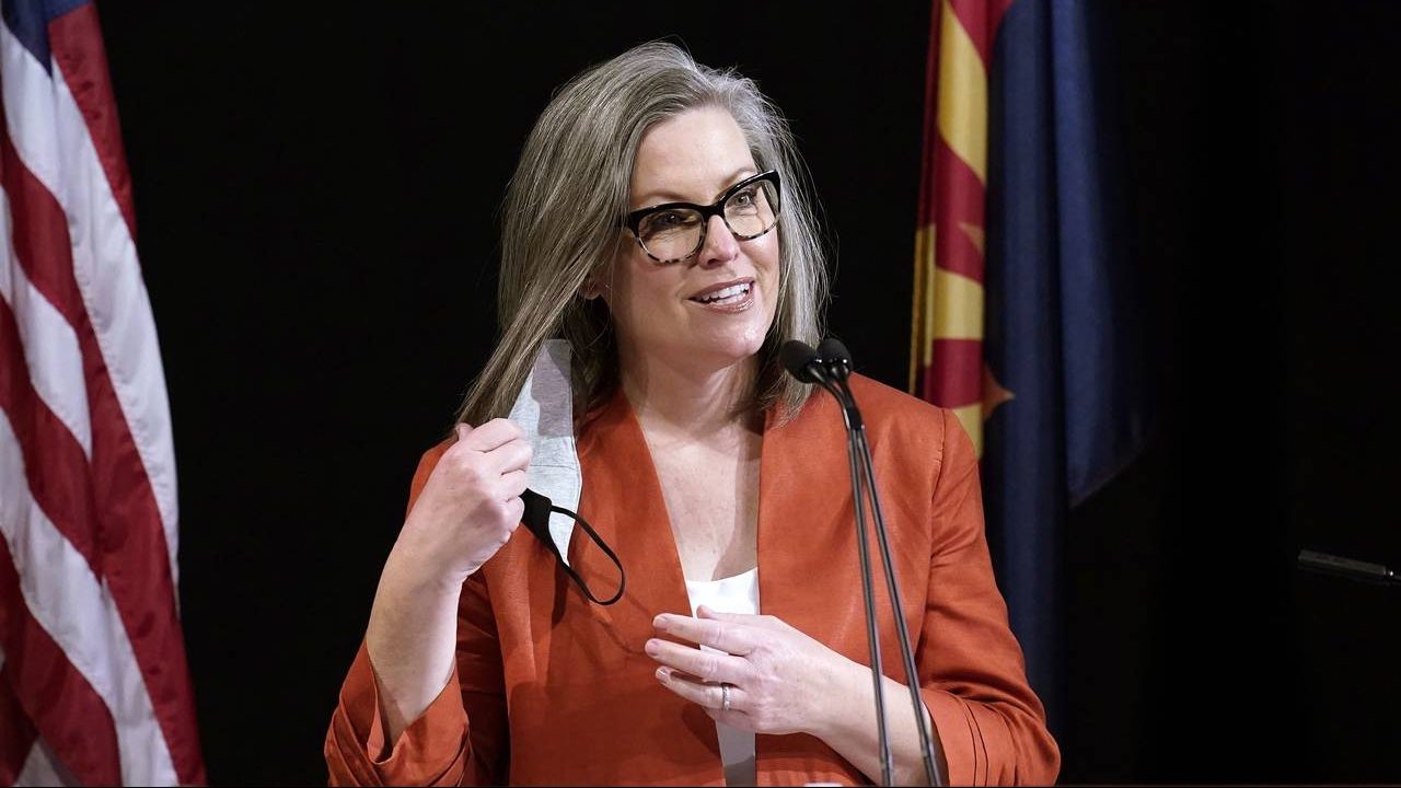 FILE - Arizona Secretary of State Katie Hobbs removes her face mask as she addresses the members of...