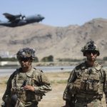 
              In this image provided by the Department of Defense, two paratroopers assigned to the 1st Brigade Combat Team, 82nd Airborne Division conduct security while a C-130 Hercules takes off during a evacuation operation in Kabul, Afghanistan, Wednesday, Aug. 25, 2021. (Department of Defense via AP)
            