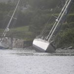 
              Two sailboats that came loose from their moorings and ran aground during Tropical Storm Henri, still sit on the rocks in Jamestown, R.I., Monday, Aug. 23, 2021. (AP Photo/Stew Milne)
            