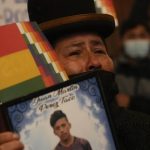 
              A woman holds a portrait of a relative who died in confrontations with security forces, during a presentation of an Independent Human Rights Experts’ report regarding the political crisis and violence of 2019 that led to the fall of former President Evo Morales, in the Central Bank of Bolivia, in La Paz, Bolivia, Tuesday, Aug. 17, 2021. (AP Photo/Juan Karita)
            