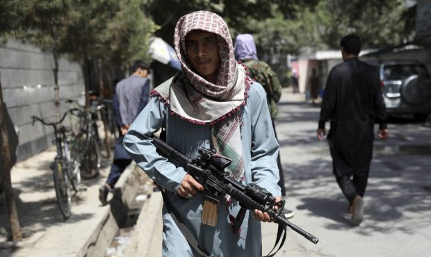 A Taliban fighter stands guard at a checkpoint in the Wazir Akbar Khan neighborhood in the city of ...