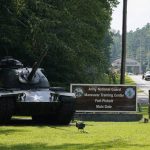 
              Traffic moves toward a tank and sign at the main entrance to Fort Pickett Wednesday, Aug. 25, 2021, in Blackstone, Va. Afghan refugees who have been prescreened by the U.S. Department of Homeland Security have been taken to Fort Lee as well as Fort Pickett according to Virginia Gov. Ralph Northam. (AP Photo/Steve Helber)
            