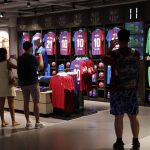 
              People take photos of Lionel Messi shirts on sale at the club's store before FC Barcelona club President Joan Laporta gives a news conference in Barcelona, Spain, Friday, Aug. 6, 2021. Barcelona announced on Thursday, Aug. 5, 2021 that Messi will not stay with the club. He is leaving after 17 successful seasons in which he propelled the Catalan club to glory, helping it win numerous domestic and international titles since debuting as a teenager. (AP Photo/Joan Monfort)
            