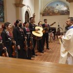 
              After a long absence Tucson's St. Augustine Cathedral's rector, the Rev. Alan Valencia welcomes back the Mariachi band Los Changuitos Feos (Ugly Little Monkeys) as they prepare to preform during their morning Mass Sunday, Aug. 18, 2021 in downtown Tucson. “Syncretism is the reality of this land, the ‘ambos’ reality,” says Valencia, the cathedral’s rector, who grew up attending mariachi Mass in “ambos Nogales,” or “both Nogales,” as locals refer to the two cities of the same name straddling the U.S.-Mexican border about 60 miles (100 kilometers) to the south. (AP Photo/Darryl Webb)
            