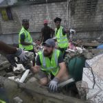 
              Canadian volunteer Randy Lodder helps search for people who may be trapped under the earthquake rubble the morning after Tropical Storm Grace swept over Les Cayes, Haiti, Tuesday, Aug. 17, 2021, three days after a 7.2 magnitude quake. (AP Photo/Fernando Llano)
            