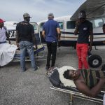 
              Residents injured by the 7.2 magnitude earthquake are taken on stretchers to a plane that will take them to the capital city of Port-au-Prince, from the airport in Les Cayes, Haiti, Thursday, Aug. 19, 2021. (AP Photo/Fernando Llano)
            