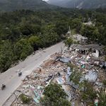 
              Homes lay in ruins along an earthquake-damaged road in Rampe, Haiti, Wednesday, Aug. 18, 2021, four days after 7.2-magnitude earthquake hit the southwestern part of the country. (AP Photo/Matias Delacroix)
            