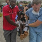 
              A man injured by the recent 7.2 magnitude earthquake is transferred to the Ofatma hospital in Les Cayes, Haiti, Thursday, Aug. 19, 2021. (AP Photo/Joseph Odelyn)
            