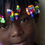 
              A girl displaced by the 7.2 magnitude earthquake looks into the camera, as she stays next to a school where residents are taking shelter in improvised tents in Les Cayes, Haiti, Wednesday, Aug. 18, 2021. (AP Photo/Fernando Llano)
            