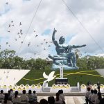 
              Doves fly over the Statue of Peace during a ceremony at Nagasaki Peace Park in Nagasaki, southern Japan Monday, Aug. 9, 2021. The Japanese city of Nagasaki on Monday marked its 76th anniversary of the U.S. atomic bombing. (Kyodo News via AP)
            