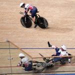 
              Laura Kenny of Team Britain (27) watches as Neah Evans (137) and another teammate crash as they compete during the track cycling women's team pursuit at the 2020 Summer Olympics, Tuesday, Aug. 3, 2021, in Izu, Japan. (AP Photo/Christophe Ena)
            