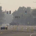 
              Smoke from wildfires in neighboring California blankets neighborhood streets in suburban Sparks, Nev., just east of Reno, Monday, Aug. 23, 2021. The Washoe County School District closed all schools including those in Reno, Sparks and parts of Lake Tahoe on Monday due to the hazardous air quality. The county health district urged the general public to "stay inside as much as possible" due to conditions expected to continue through Wednesday. (AP Photo/Scott Sonner)
            
