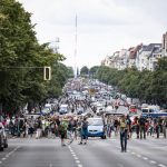 
              Demonstrators walk along Bismarckstrasse in Berlin, Sunday Aug. 1, 2021, during a protest against coronavirus restrictions. (Fabian Sommer/dpa via AP)
            