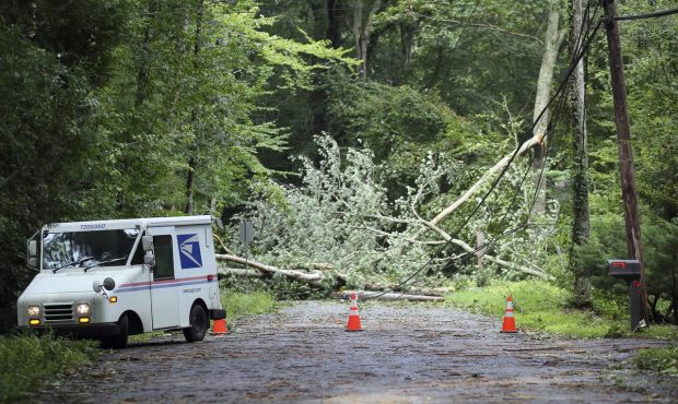 A U.S. Postal truck has to turn around as Gardner Rd. in Exeter, R.I., is completely blocked by a d...