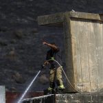 
              An Israeli firefighter works to extinguish a fire caused by rocket fired from Lebanon into Israeli territory near the northern Israeli town of Kiryat Shmona, Wednesday, Aug. 4, 2021. Three rockets were fired from Lebanon into Israeli territory Wednesday and the army fired back, Israel's military said. There was no immediate information on damages or casualties. (AP Photo/Ariel Schalit)
            