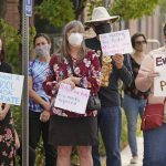 
              Parents and students hold rally at Utah State School Board Office calling for mask mandate Friday, Aug. 6, 2021, in Salt Lake City. The school year is days away for many kids in Utah and public health experts are worried about whether kids too young to get vaccinated will stay safe in school amid a wave of coronavirus cases. (AP Photo/Rick Bowmer)
            