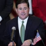 FILE - In this April 15, 2021, file photo, Arizona Republican Gov. Doug Ducey speaks during a bill signing in Phoenix. The Arizona Supreme Court is set to release its decision, Thursday, Aug. 19, 2021, in a constitutional challenge to a new tax on high earners that was designed to increase school funding and approved by the state's voters in November. Ducey opposed the new tax and said he hopes the state's high court finds it unconstitutional. (AP Photo/Ross D. Franklin, File)