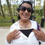 
              R. Kelly supporter Carlotte Woods, of Kentucky shows his name tattooed on her chest outside Brooklyn Federal court during a lunch break in R&B star's trial, Thursday, Aug. 19, 2021, in New York. (AP Photo/Mary Altaffer)
            