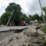 
              Residents walk on a damaged road in Rampe, Haiti, Wednesday, Aug. 18, 2021, four days after 7.2-magnitude earthquake hit the southwestern part of the country. (AP Photo/Matias Delacroix)
            