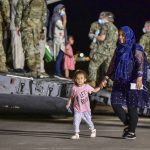 
              CORRECTS PHOTOGRAPHER TO DANIEL YOUNG - Evacuees from Afghanistan disembark from a U.S. Air Force C-17 Globemaster III  at the Sigonella US air base, in Sicily, southern Italy, Sunday, Aug. 22, 2021. People fleeing Afghanistan arrived at the U.S. naval air base in Sicily as Washington tried to ramp up evacuations following the Taliban takeover of the country by using overseas military bases as temporary transit points. (Daniel Young/U.S. Navy via AP)
            