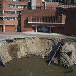 
              A section of the Rosario River bank is eroded right in front of a high school, triggered by a drought in Rosario, Argentina, Friday, July 30, 2021. The Parana River Basin and its related aquifers provide potable water to close to 40 million people in South America, and according to environmentalists the falling water levels of the river are due to climate change, diminishing rainfall, deforestation and the advance of agricultural frontier. (AP Photo/Victor Caivano)
            