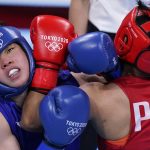 
              Philippines's Nesthy Petecio, right, exchanges punches with Japan's Sena Irie during their women's featherweight 60-kg final boxing match at the 2020 Summer Olympics, Tuesday, Aug. 3, 2021, in Tokyo, Japan. (AP Photo/Frank Franklin II)
            