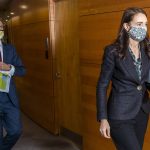 
              New Zealand Prime Minister Jacinda Ardern, right, walks to a press conference to give a COVID-19 response update at Parliament, Wellington, New Zealand, Wednesday, Aug. 18, 2021. Ardern announced people will be compelled to wear masks in supermarkets, gas stations and pharmacies during strict lockdowns. That came after the government on Tuesday imposed a strict lockdown of at least three days for the entire country and at least seven days in Auckland and Coromandel after identifying the first infection. (Mark Mitchell/New Zealand Herald via AP)
            