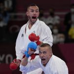 
              Steven de Costa of France, top, and Kalvis Kalnins of Latvia react during the men's kumite -67kg elimination round for Karate at the 2020 Summer Olympics, Thursday, Aug. 5, 2021, in Tokyo, Japan. (AP Photo/Vincent Thian)
            