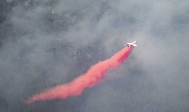 An aircraft drops red fire retardant onto the Greenwood Fire, about 50 miles north of Duluth, Minn....