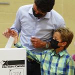 
              Liberal leader Justin Trudeau casts his ballot in the 44th general federal election as he's joined by his son Hadrien in Montreal on Monday, Sept. 20, 2021. (Sean Kilpatrick/The Canadian Press via AP)
            