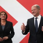 
              Olaf Scholz, Finance Minister and SPD candidate for Chancellor, gives the thumb-up sign as he stands next to his wife Britta Ernst during the election party at Willy Brandt House in Berlin, Sunday, Sept. 26, 2021. Exit polls show the center-left Social Democrats in a very close race with outgoing Chancellor Angela Merkel’s bloc in Germany’s parliamentary election, which will determine who succeeds the longtime leader after 16 years in power. (Wolfgang Kumm/dpa via AP)
            