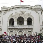 
              Tunisian demonstrators gather outside the Municipal Theatre of Tunis during a protest against Tunisian President Kais Saied, Saturday, Sept. 18, 2021. In July Tunisian President Kais Saied fired the country's prime minister and froze parliament's activities after violent demonstrations over the country's pandemic and economic situation. The movement made by Saied was considered by his opponents as a coup. (AP Photo/Riadh Dridi)
            