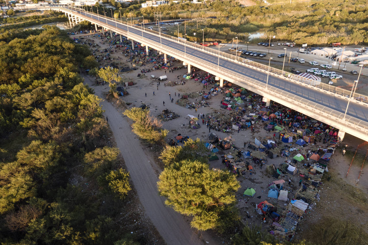 Migrants, many from Haiti, are seen in an encampment along the Del Rio International Bridge near th...