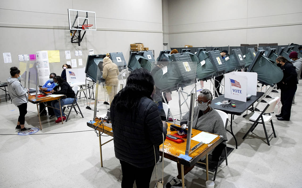 FILE - Voters cast their ballots for the general election at Victory Houston polling station, one o...