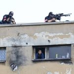 
              Snipers stand of a roof waiting for Pope Francis to meet members of the Roma community at Lunik IX, the biggest of about 600 shabby, segregated settlements where the poorest 20% of Slovakia's 400,000 Roma live. Slovakia, Tuesday, Sept. 14, 2021. Pope Francis traveled to Kosice, in the far east of Slovakia on Tuesday to meet with the country's Roma in a gesture of inclusion for the most socially excluded minority group in Slovakia, who have long suffered discrimination, marginalization and poverty. (AP Photo/Petr David Josek)
            